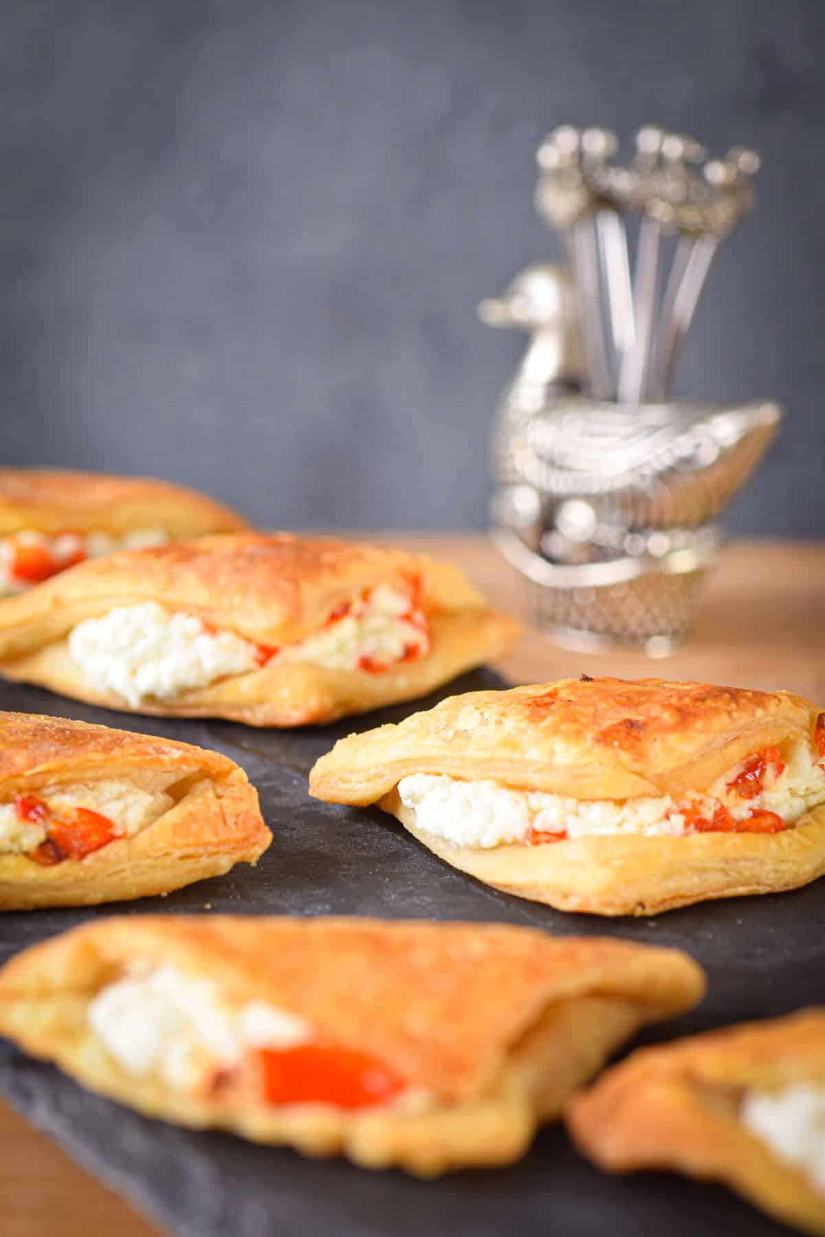 Goat cheese triangles on a black serving dish.