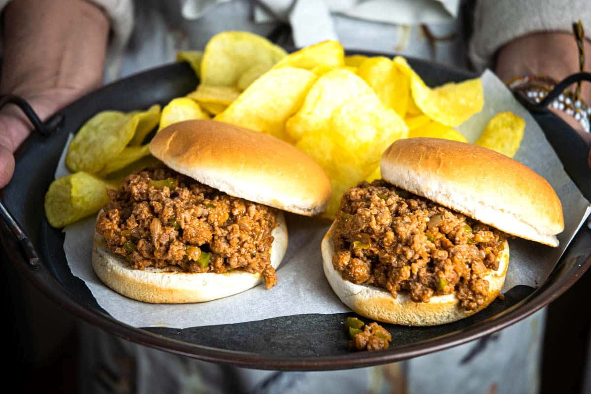 Sloppy Joes on a serving dish with chips.