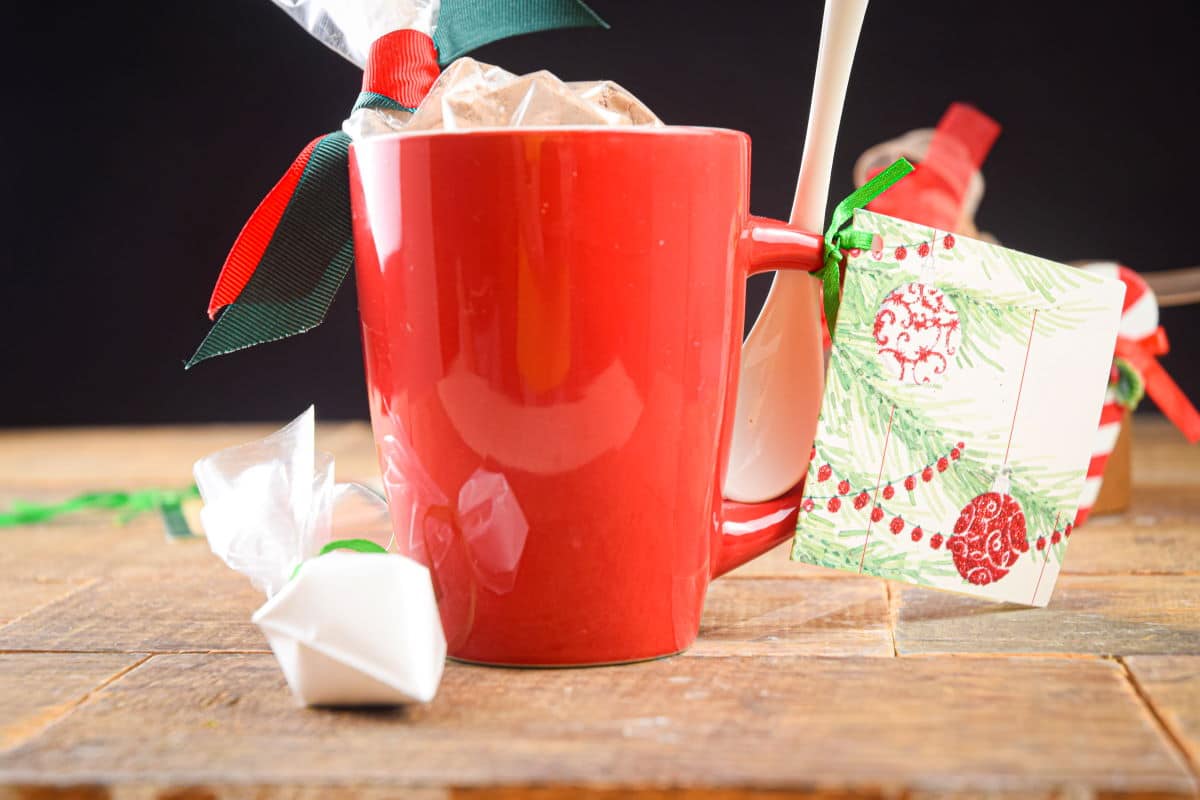 Chocolate cake ingredients in a red mug with Christmas decorations.