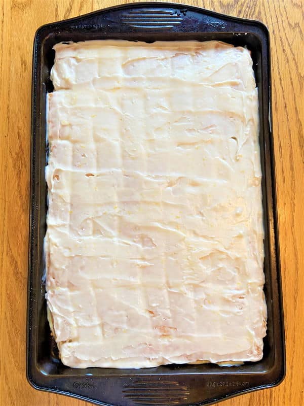 Graham Wafer Lemon Squares on a baking sheet, wooden background.