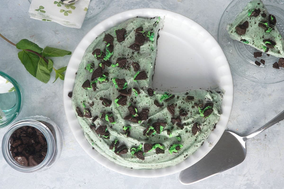 Grasshopper pie in ceramic pie plate with a slice on the side.