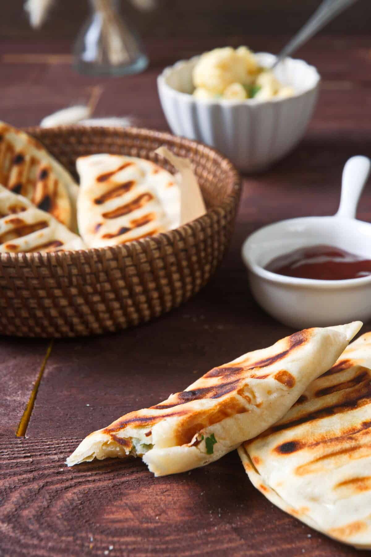 Grilled pierogies on wooden background.