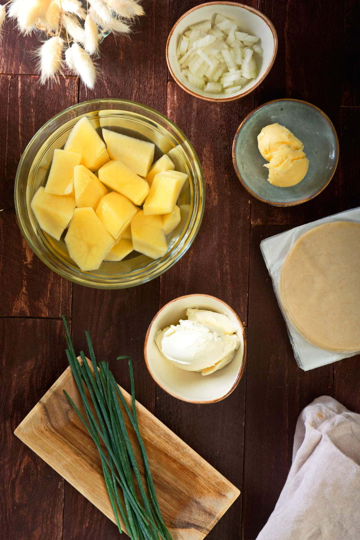 Pierogi ingredients prepped on wooden background.