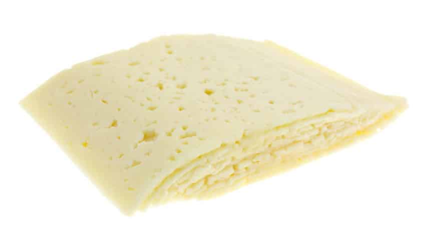 Havarti cheese slices on white background.