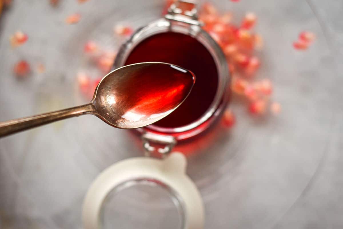 Homemade grenadine in a spoon close up.