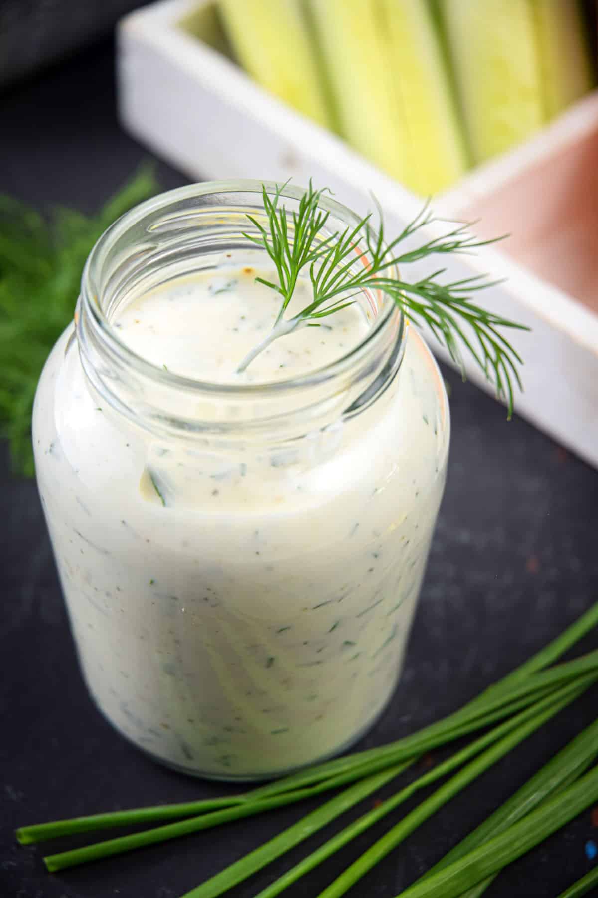 Homemade ranch dressing in a jar with fresh dill.