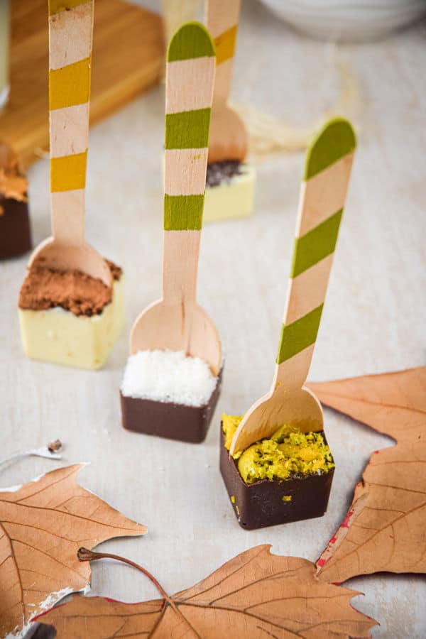 Hot chocolate spoons standing up on light background.