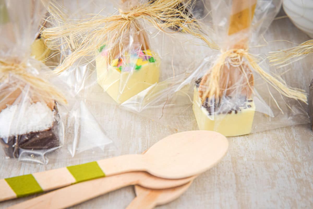 Hot chocolate spoons with toppings wrapped up in clear plastic.