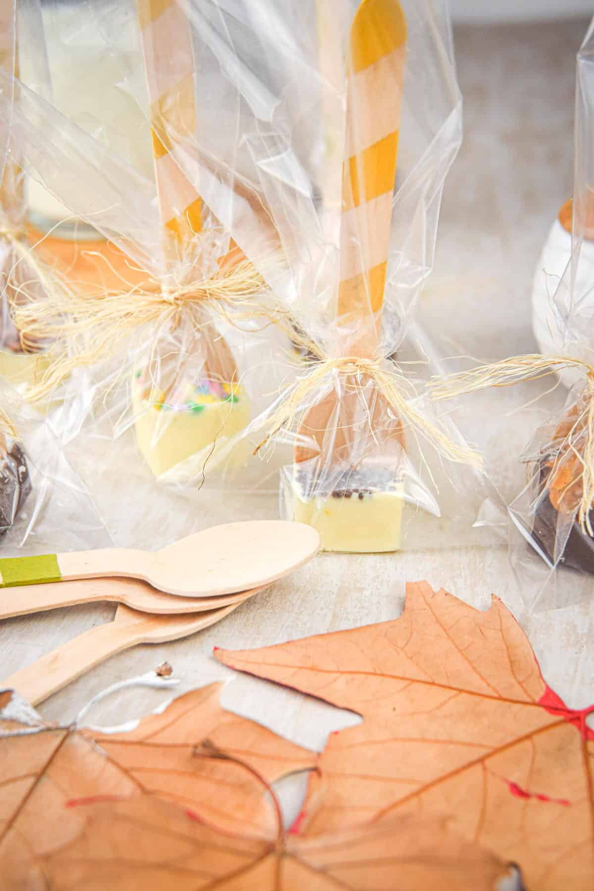 Hot chocolate spoons with toppings wrapped up in clear plastic.