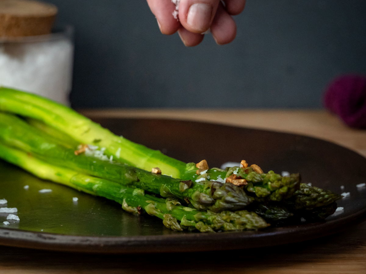 Asparagus on plate with flake salt.