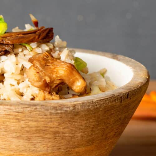 Cooked brown rice in wooden bowl.