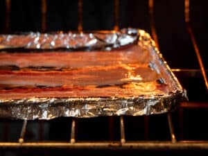 Bacon in the oven on foil-lined sheet pan.