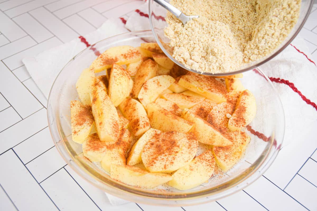 Apples and cinnamon in pie dish.