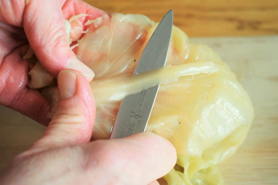 A sour cabbage leaf with a knife.