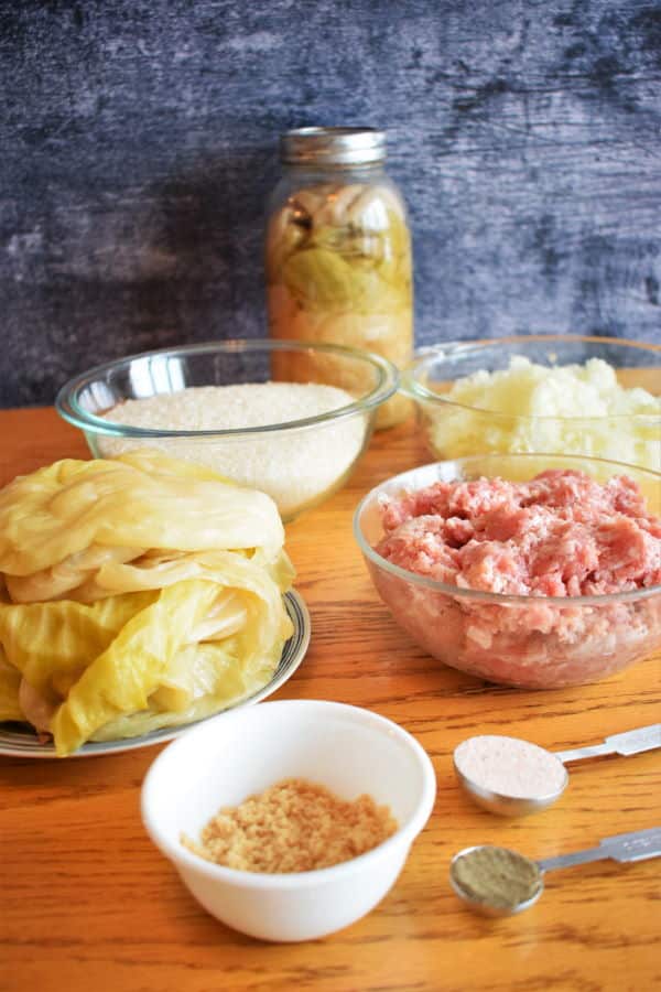 Cabbage roll ingredients on wooden background.