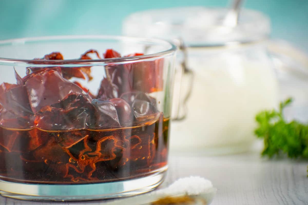 Chipotle peppers in adobo sauce on blue background.