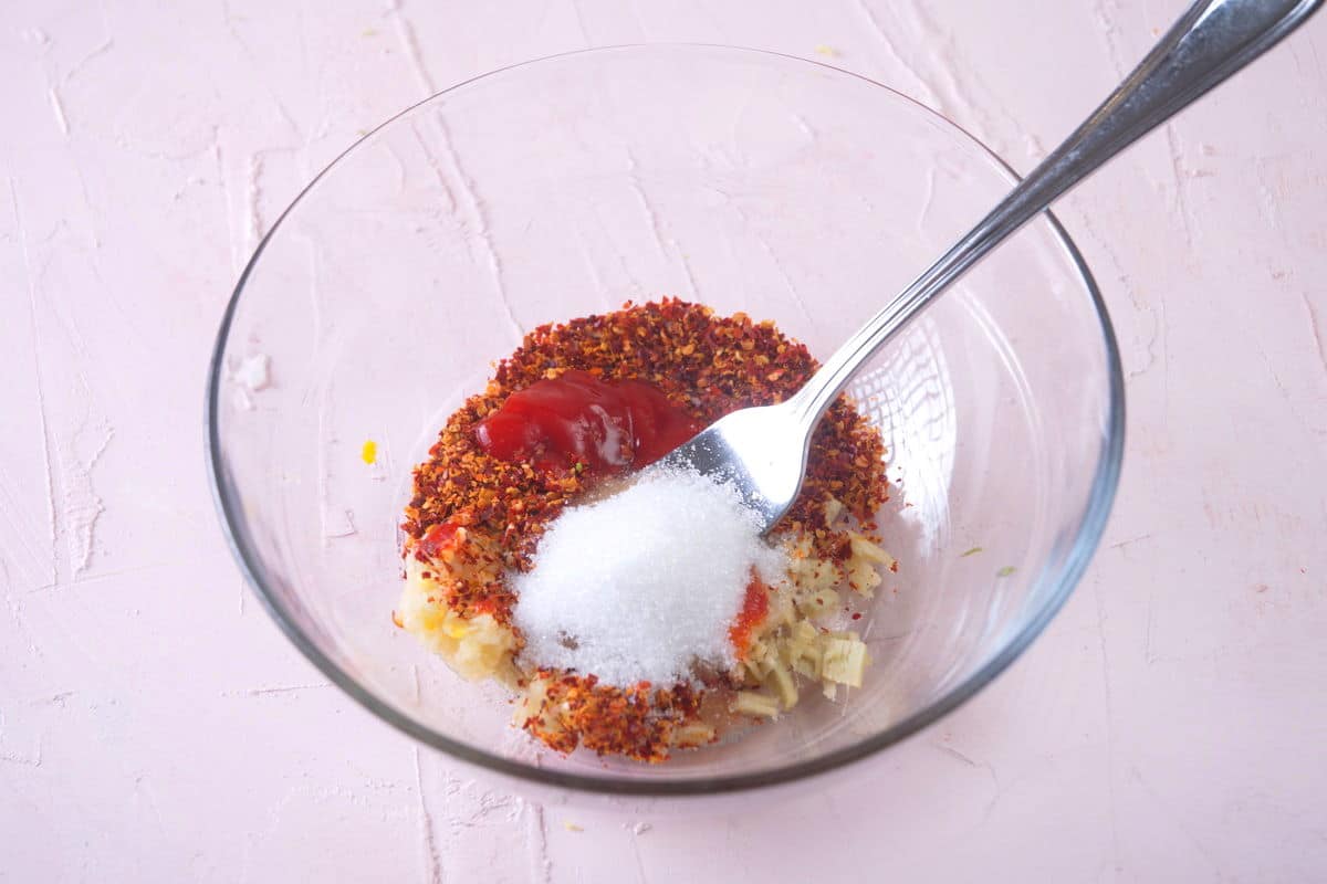 Kimchi spices in a small bowl with a fork.