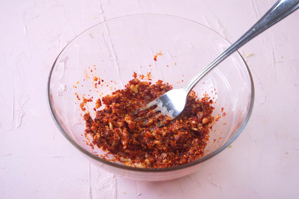 Kimchi spices in a small bowl with a fork.
