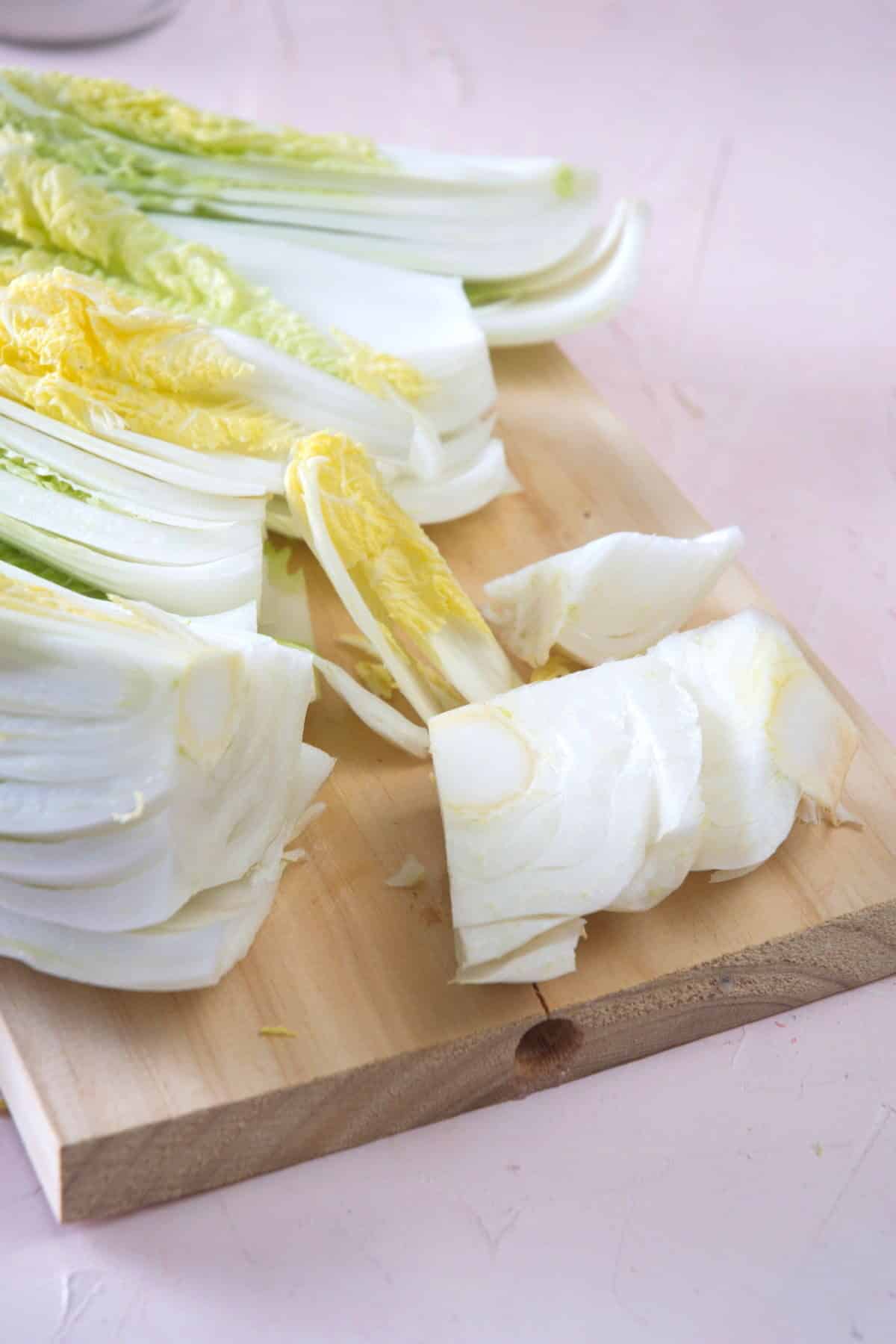 Cored Napa cabbage on a cutting board.