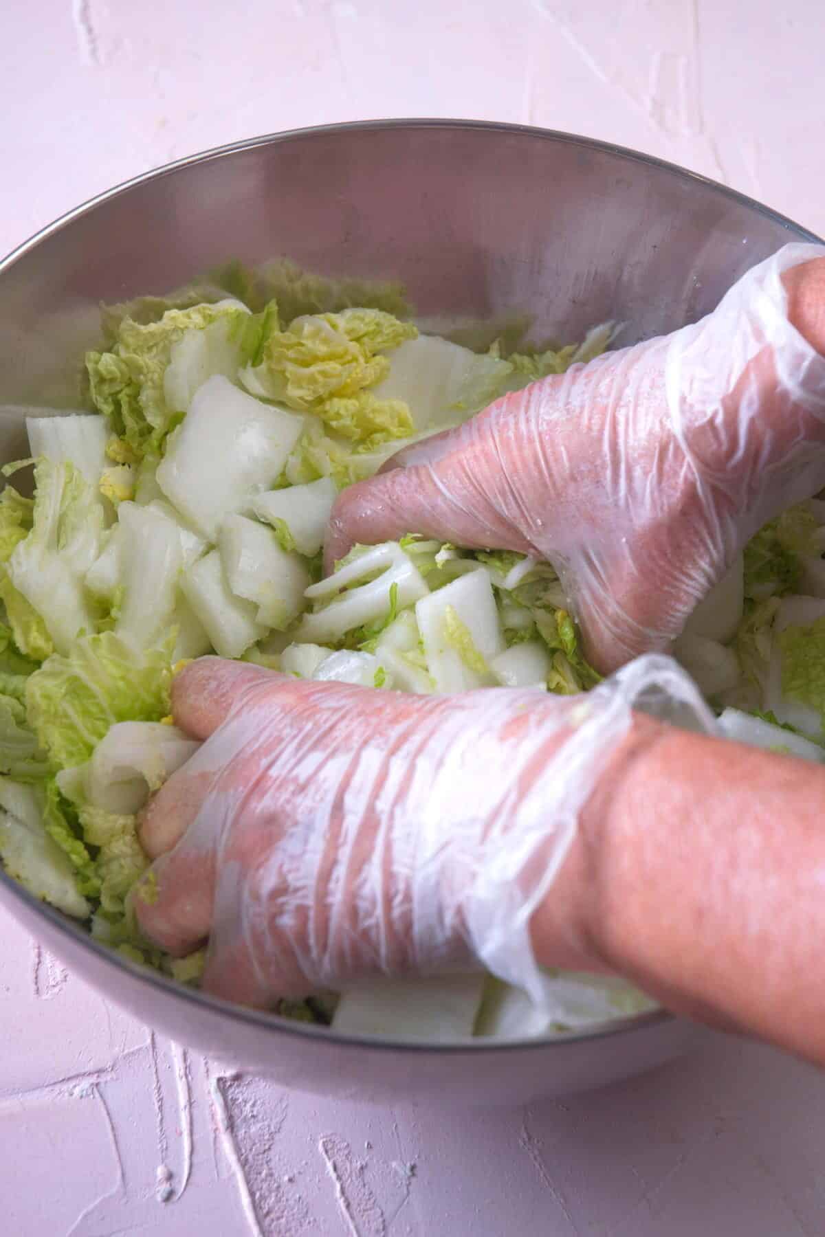Chopped Napa cabbage in a large steel bowl.
