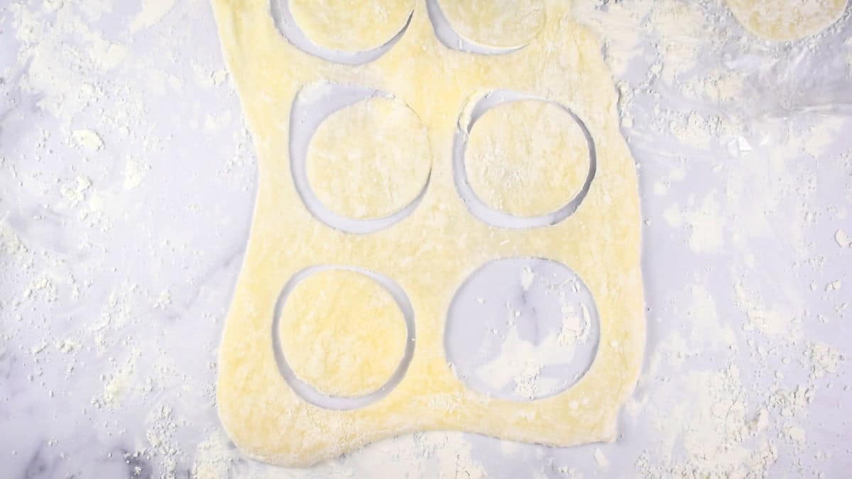 Dough circles on floured surface.