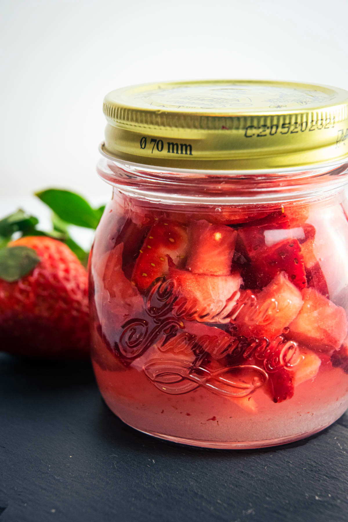 Vodka strawberry infusion in a jar.