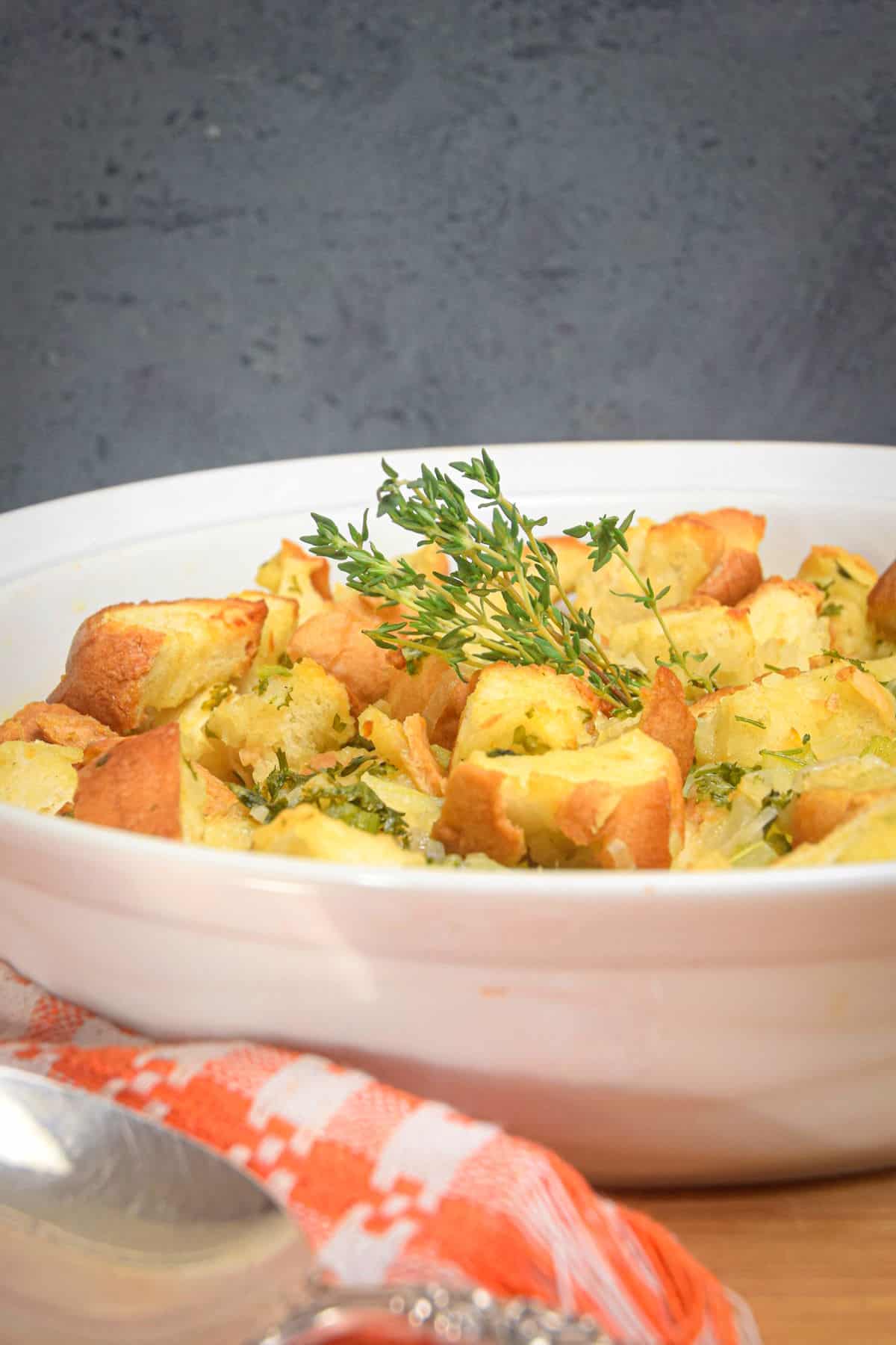 Stuffing with fresh thyme in white bowl.