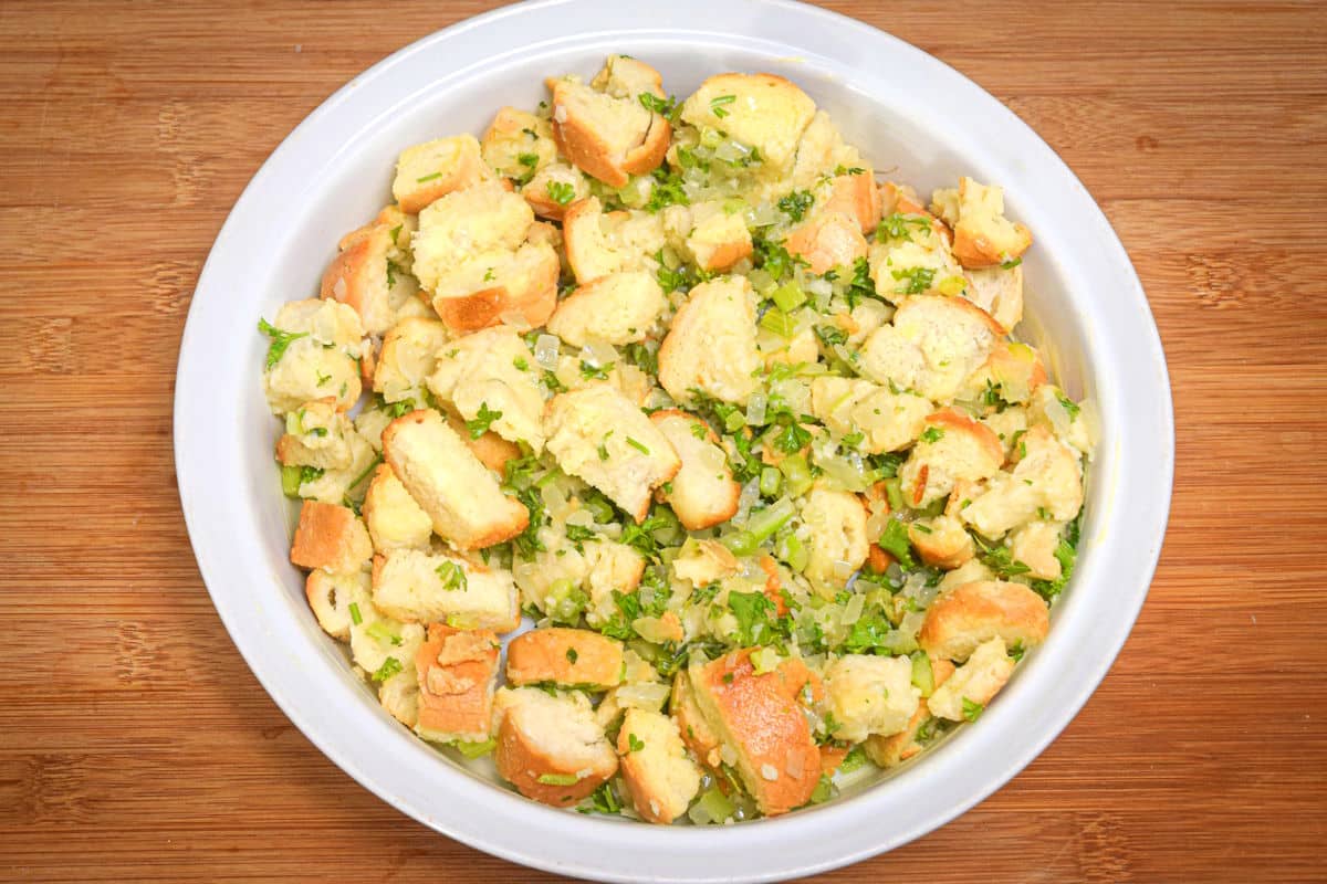 Raw stuffing mix in a white bowl.