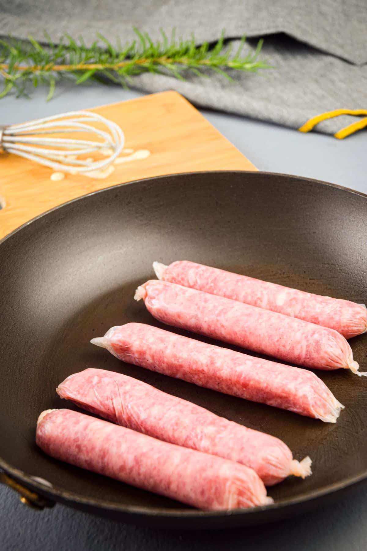English sausages in frying pan.