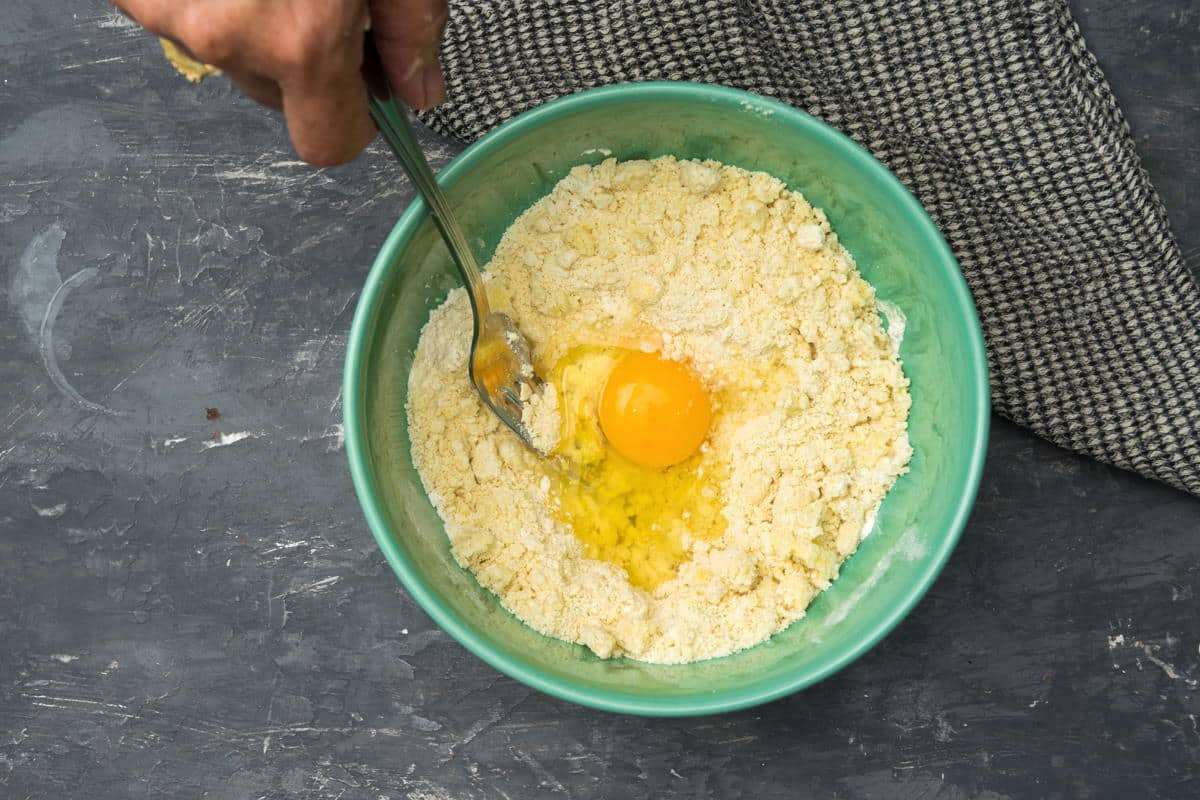 Flour and butter in a bowl with an egg.