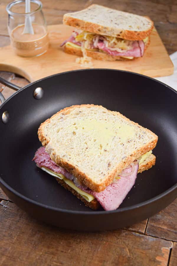 Reuben sandwich in a frying pan.