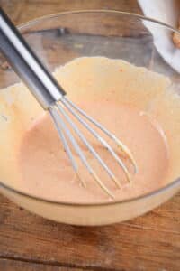 Bowl of Russian dressing and a whisk.