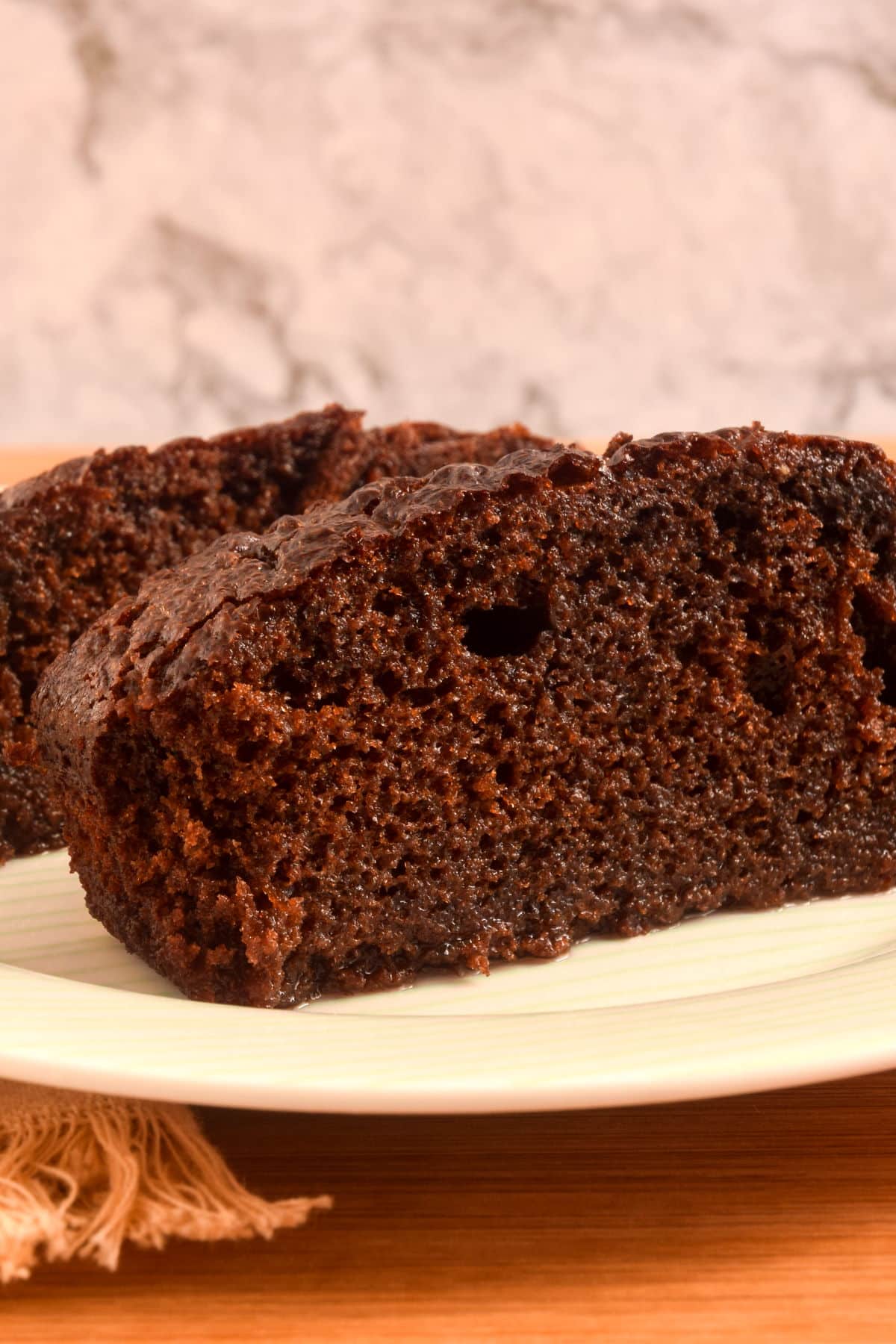 Moist chocolate cake on plate.