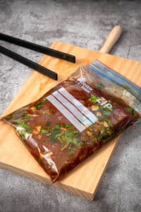 Flank steak and marinade in zip top bag.