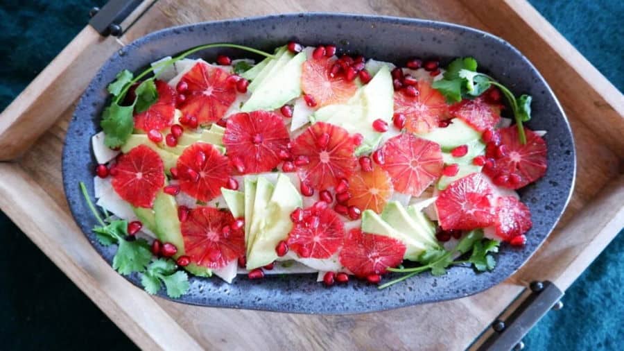 Jicama salad in wide blue bowl.