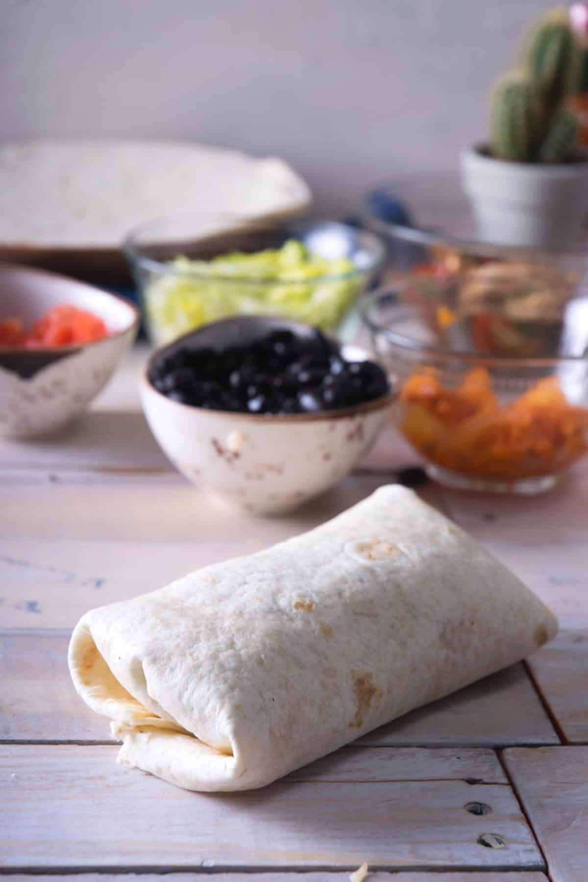 Burrito on wooden background.