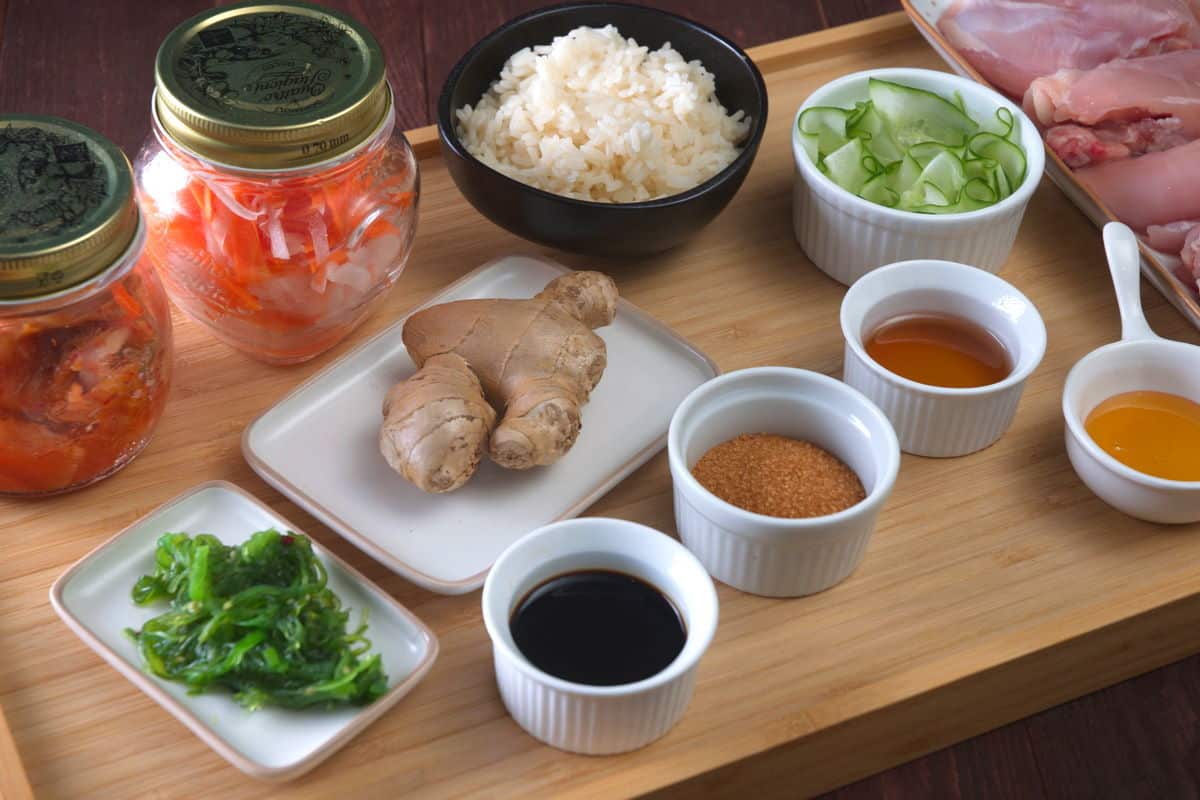 Kimchi rice bowl ingredients prepped on wooden board.