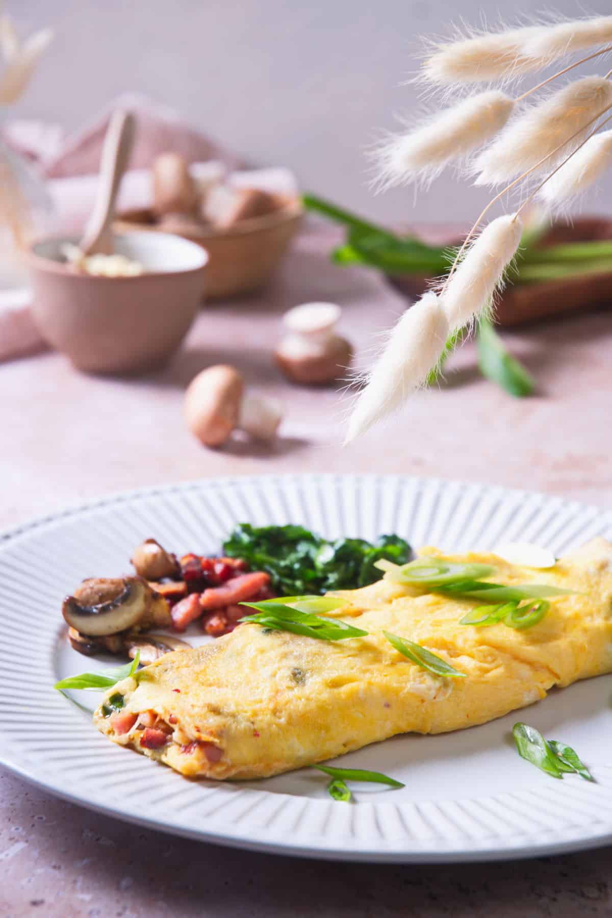 Kimchi omelette on white plate with sliced scallions.