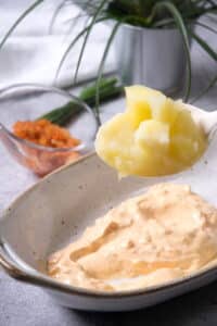 Kimchi mayo and potatoes in small casserole dish.