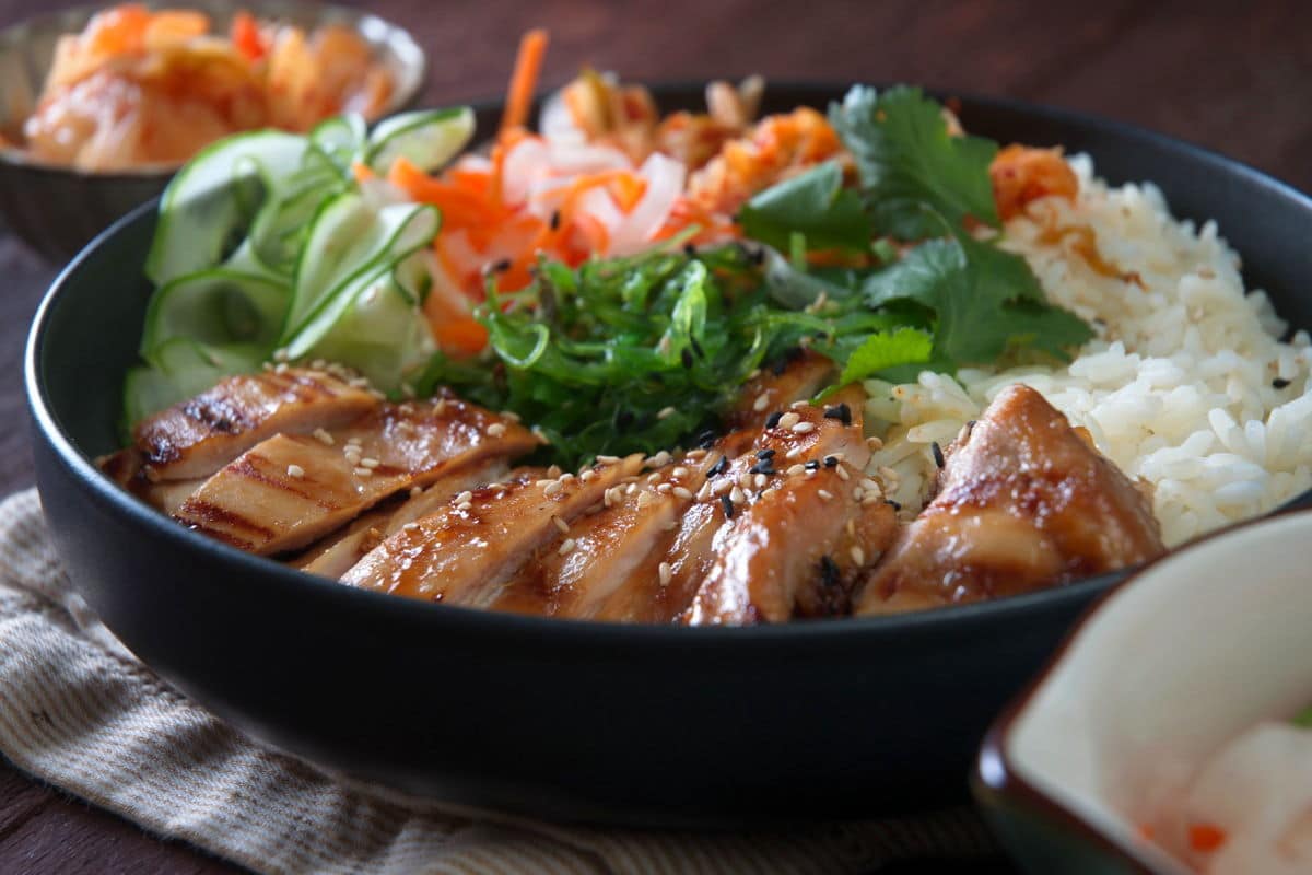 Kimchi rice bowl on wooden background, front view.