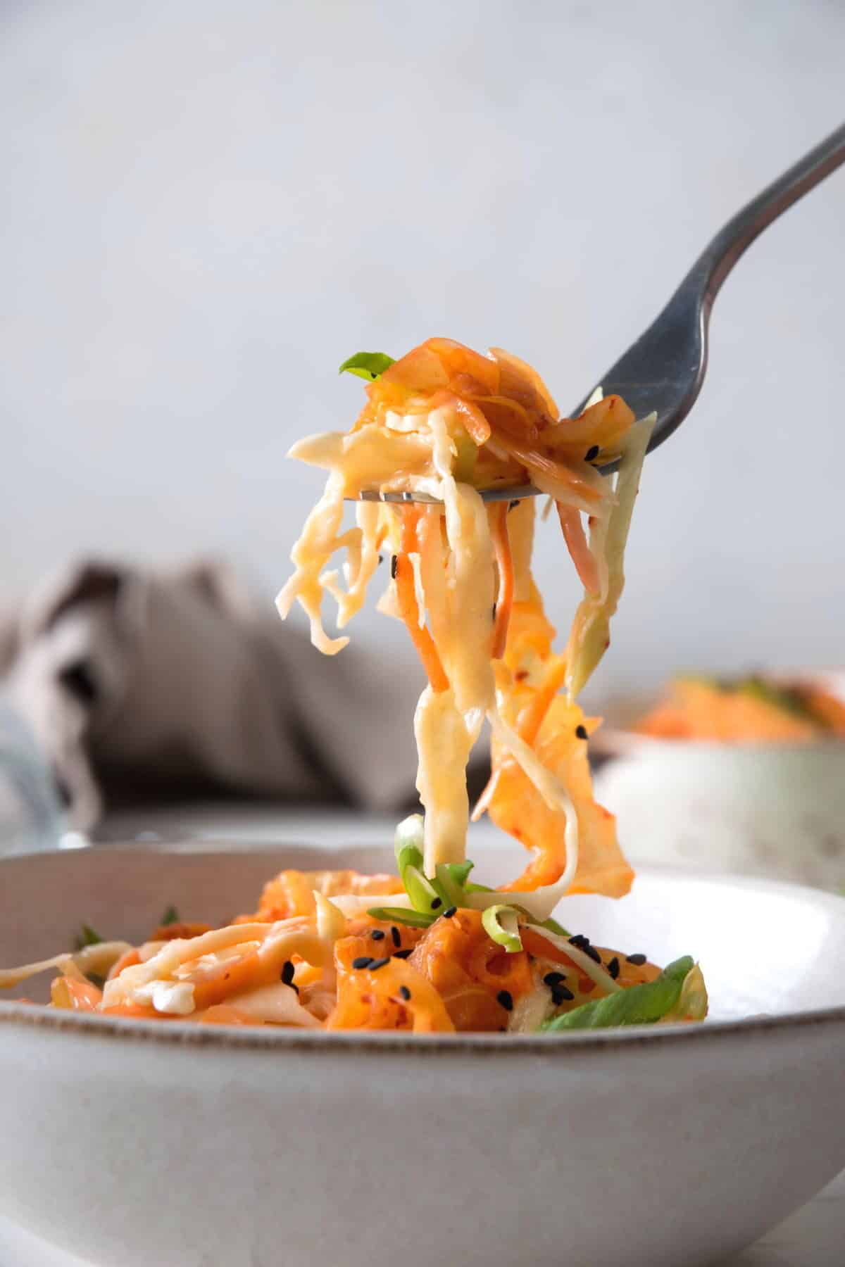 Kimchi and crab slaw in a bowl with a fork.