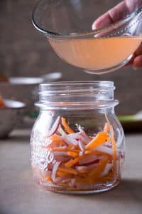 Small jar of matchstick carrots and daikon radish.