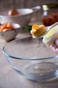 Glass bowl with cooked egg yolk.