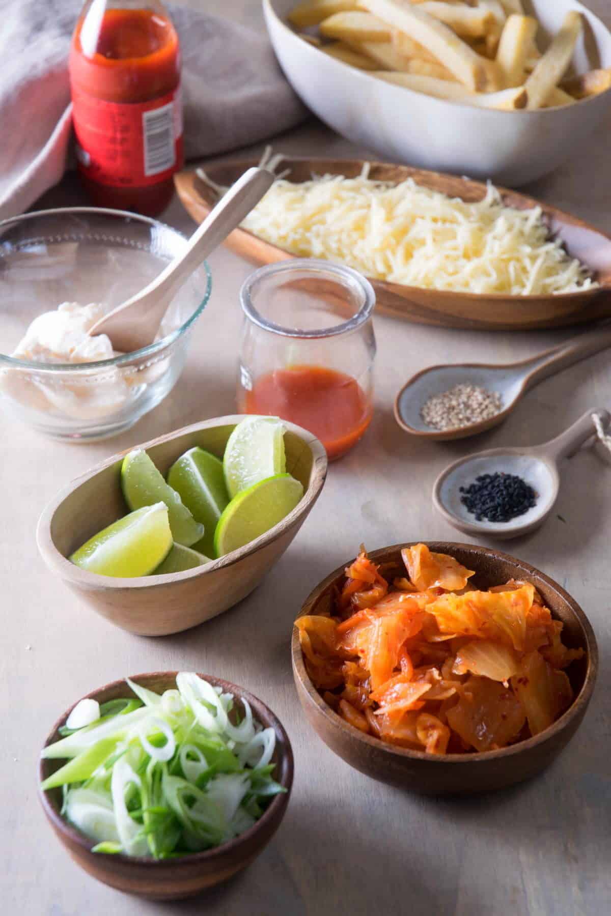 Kimchi fries prepped ingredients on light background.