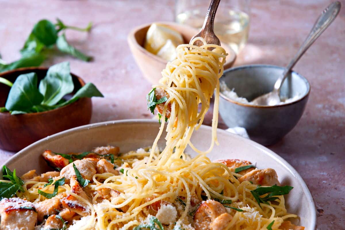 Angel hair pasta twirled around a fork.