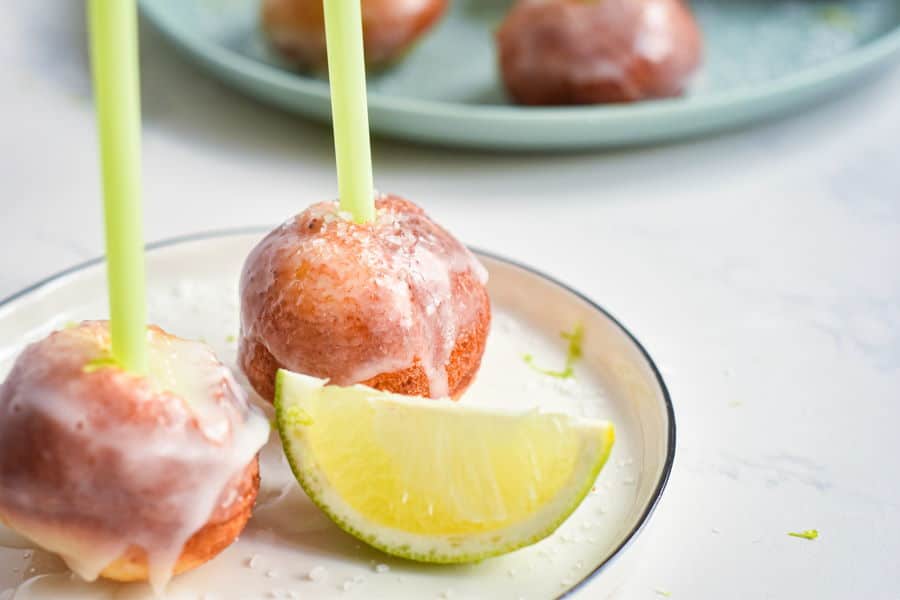 Cake Pop Maker Margarita Cake Pops on a white plate with a lime wedge, marble background.