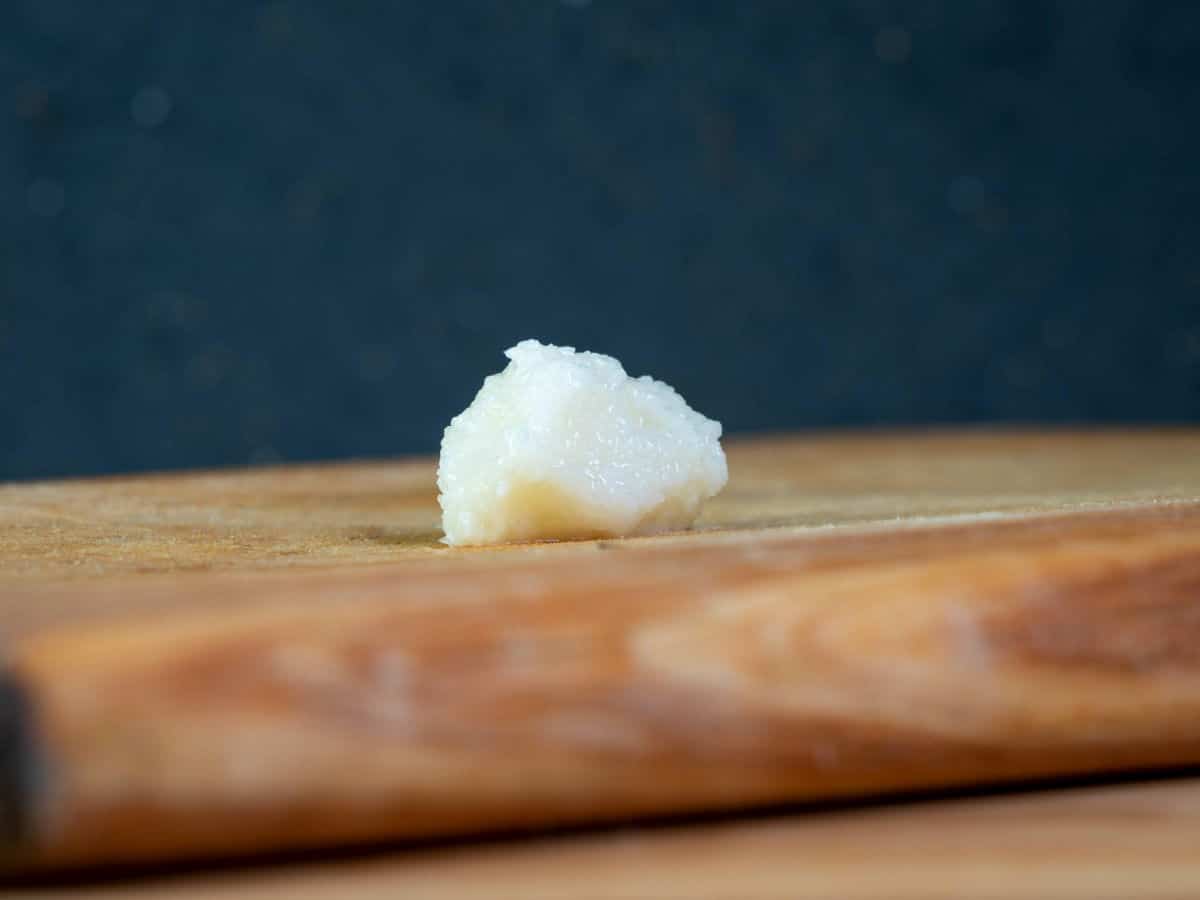 Minced garlic on cutting board.