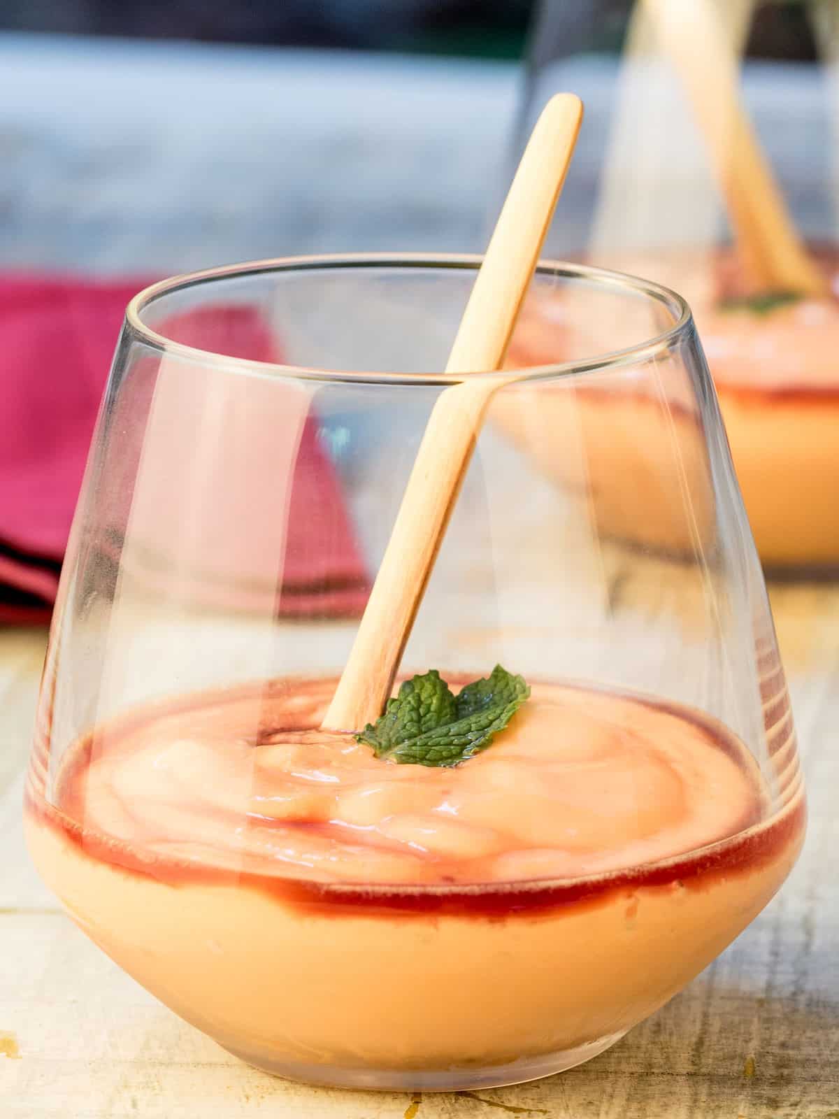 Papaya Cream with Cassis Liqueur in a wine glass with fresh mint.