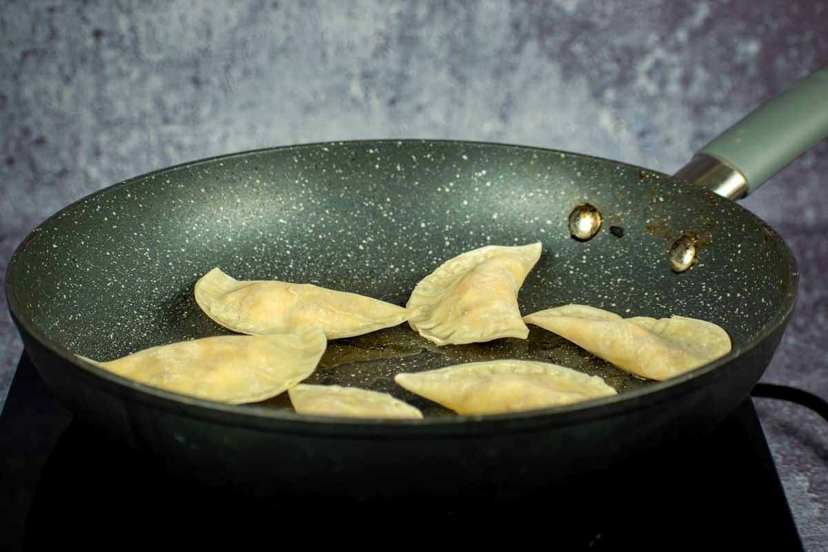 Pan with raw pierogies in it.