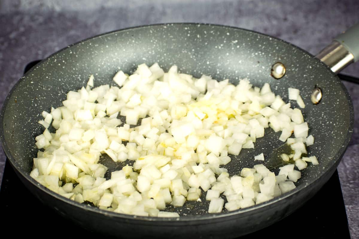 Raw, diced onions in pan.